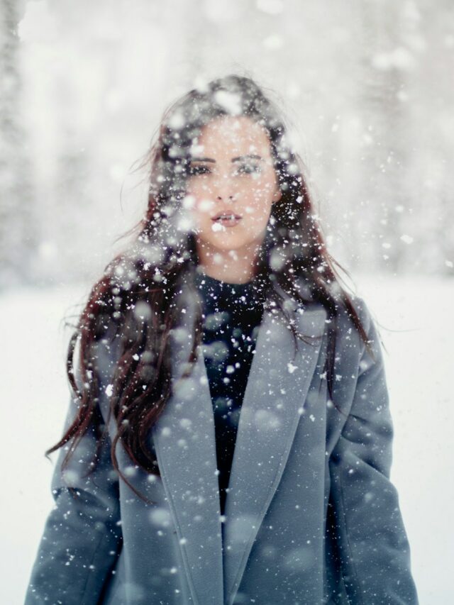 selective focus photograph of woman in gray coat
