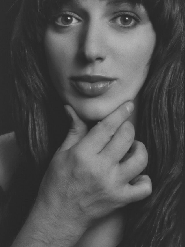 grayscale photo of woman in scoop top