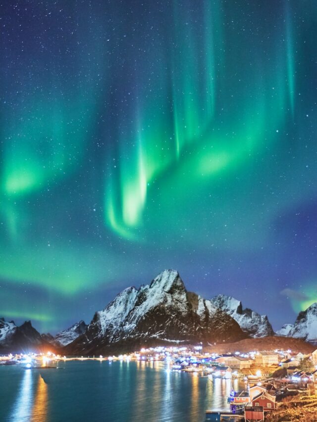 snow covered mountains near body of water during night time